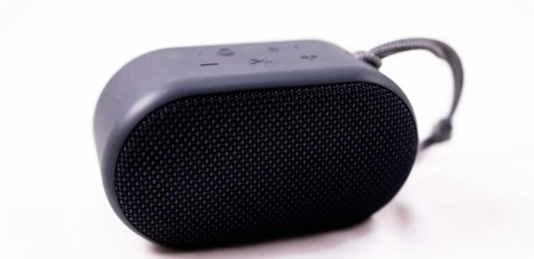 Portable Bluetooth speaker with carrying strap