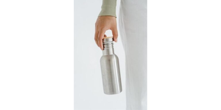 Stainless steel water bottle held in hand